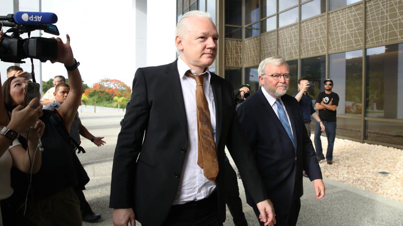 Julian Assange is joined by Kevin Rudd, Australian Ambassador to the US, outside court in Saipan. . 