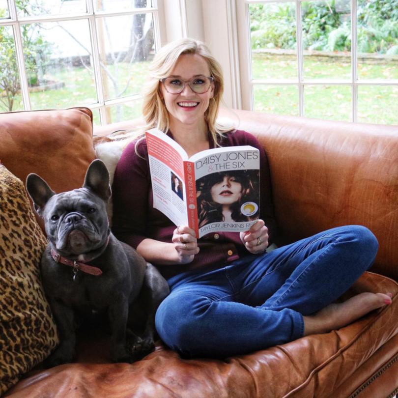 Reese Witherspoon reading Taylor Jenkins Reid’s Daisy Jones & The Six, which her production company is turning into a TV show.