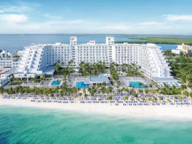 A man has been shot dead on the beach behind a luxury hotel in Cancun.