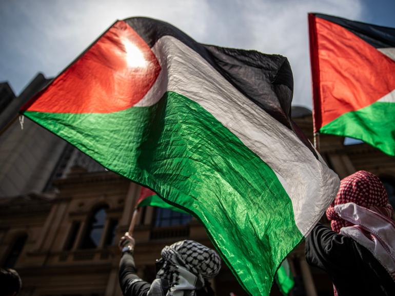 Pro-Palestinian demonstrators gather during a protest at Town Hall in Sydney.