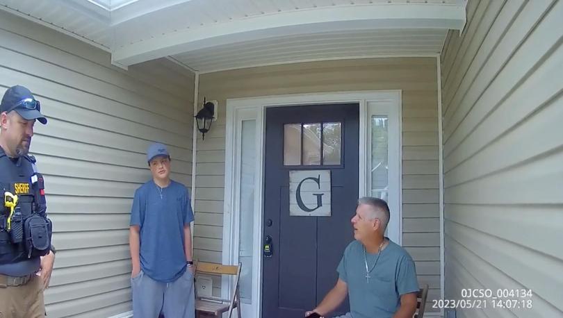 A still taken from a Jackson County sheriff’s body camera shows Colt Gray, second from left, answering questions about profane messages relating to a Discord account as his father, Colin Gray, is seated at right. 