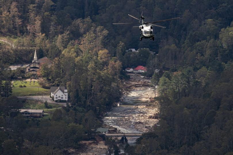 A Marine helicopter accompanying Marine One flies over damage from Hurricane Helene.