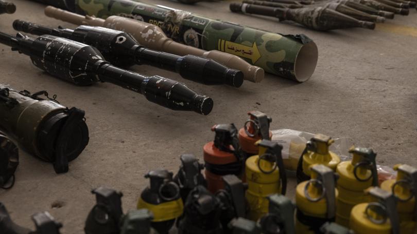 A cache of Hamas weapons is displayed at a military base in southern Israel on Oct. 20, 2023.