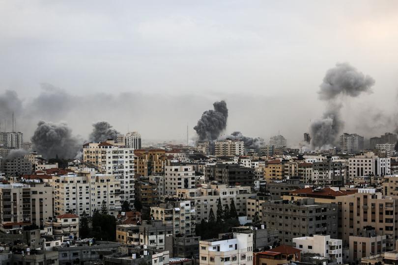 A smoke rises over a buildings in Gaza City on October 9 during an Israeli air strike.