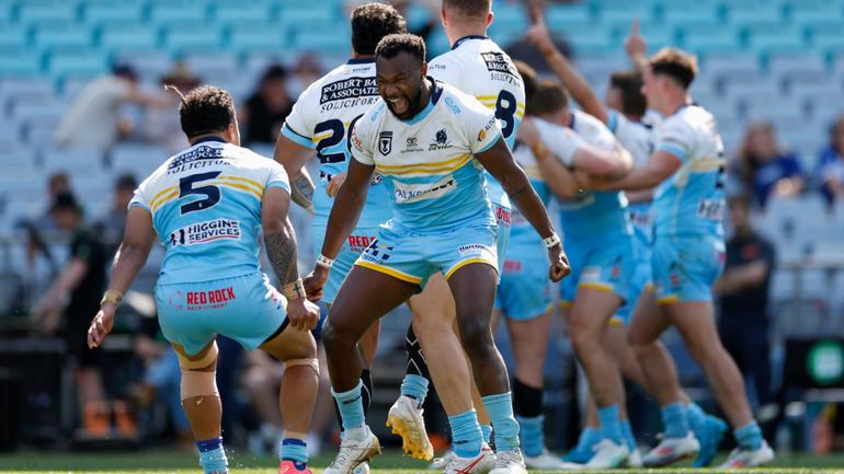 Manase Kaho and Jeremiah Simbiken of the Devils celebrate winning the NRL State Championship Grand Final.