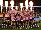 Isaah Yeo and Nathan Cleary of the Panthers hold aloft the Provan-Summons Trophy with a jubilant Penrith team.