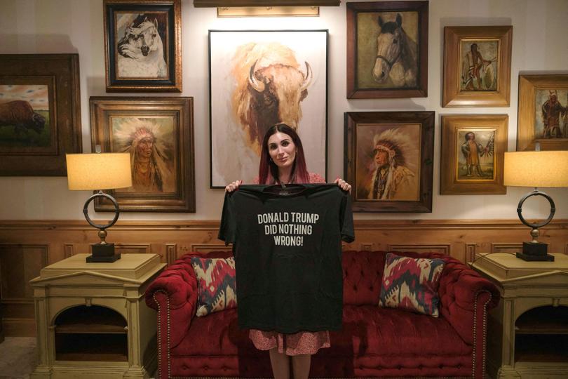 Laura Loomer holds a T-shirt she designed with the words ‘Donald Trump Did Nothing Wrong’ at The Villages, FL, USA. 