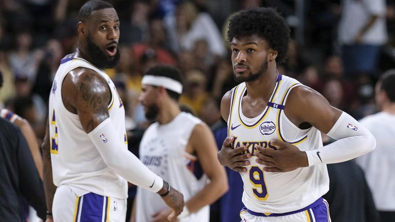 LeBron and Bronny James get a real kick out of playing together for the first time. (AP PHOTO)