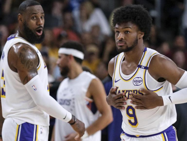 LeBron and Bronny James get a real kick out of playing together for the first time. (AP PHOTO)