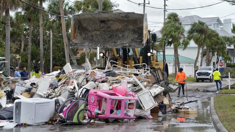 Crews are working to remove debris from Hurricane Helene before Hurricane Milton approaches Florida's west coast. (AP Photo/Chris O'Meara)