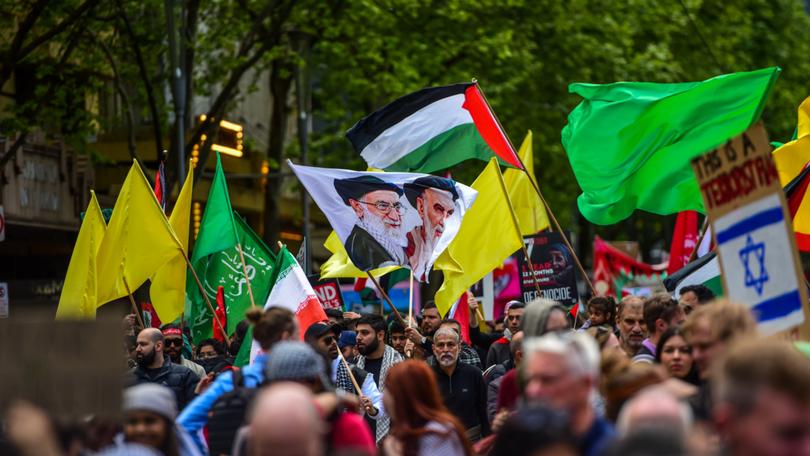 A flag with Ali Khamenei and Ali al-Sistani together with plain yellow flags replacing flags of Hezbollah are seen during the latest pro-Palestinian protest on the streets of Melbourne.