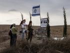 People stop along a main road in southern Israel on Oct 6 near the border with Gaza to visit a memorial site for Eli Refai, Sharon Refai, Shahar Mansour and Oriya Litman Ricadro, who were killed fleeing the SuperNova music festival during the Hamas-led assault on southern Israel last Oct 7.