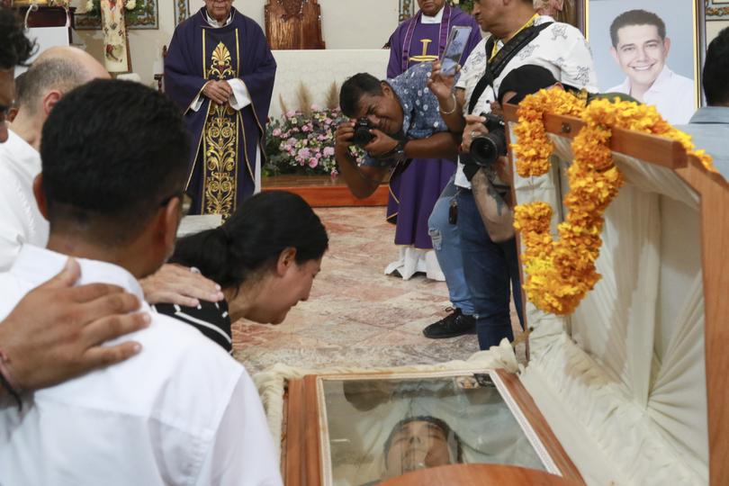 Relatives of slain Mayor Alejandro Arcos cry during his funeral service.