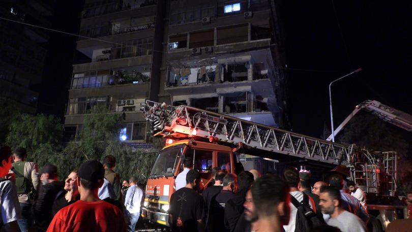 Syrian rescuers inspect the damage after missiles fell on the building in the Al-Mazzeh neighbourhood in Damascus, Syria.