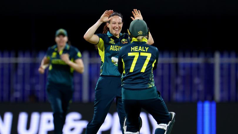 Megan Schutt celebrates with teammate Alyssa Healy after dismissing Georgia Plimmer of New Zealand.