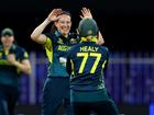 Megan Schutt celebrates with teammate Alyssa Healy after dismissing Georgia Plimmer of New Zealand.