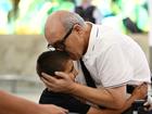 People embrace as Australian nationals arrival on a repatriation flight at Sydney International Airport.