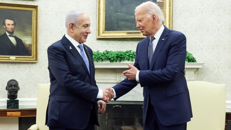 Joe Biden shakes hands with Benjamin Netanyahu.