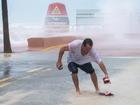 A man retrieves a sandal from a flooded street around the Southernmost Point ahead of Hurricane Milton. Hurricane Milton is forecast to make landfall along Florida's Gulf coast as a major hurricane is expected. (Photo by Jen Golbeck / SOPA Images/Sipa USA)