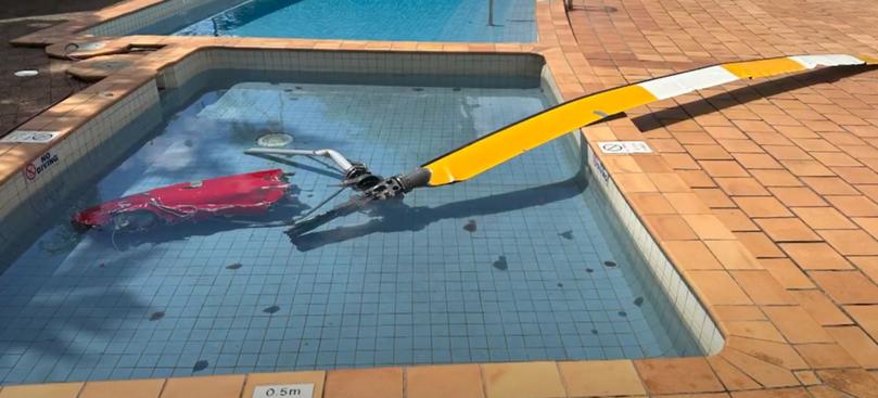 Part of the wreckage from the helicopter crash lies in the hotel pool in Cairns.