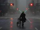 Ron Rook walks through windy and rainy conditions on a deserted street in downtown Tampa, Florida, during the approach of Hurricane Milton.