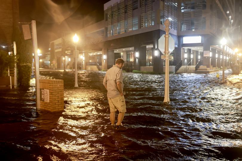 People are waiting to assess the damage after the Category Three hurricane came ashore. (Photo by Joe Raedle/Getty Images)