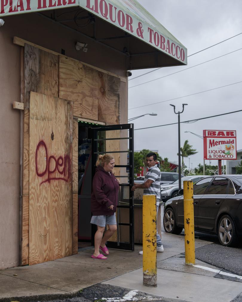 People leave Mermaid Liquor & Tobacco before Hurricane Milton makes landfall.