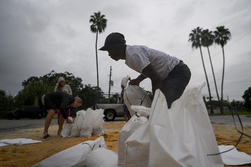 Willet Jean fills sandbags, in Orlando.