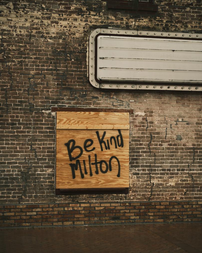 A boarded up window reading “Be kind Milton”, in Sarasota.