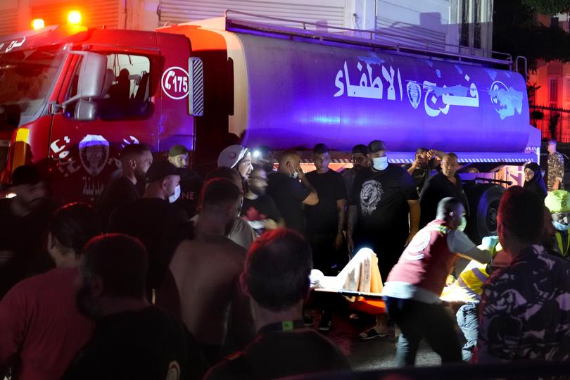 Paramedics carry a victim from a destroyed building hit by an Israeli airstrike in central Beirut, Lebanon, Thursday, October 10, 2024. 