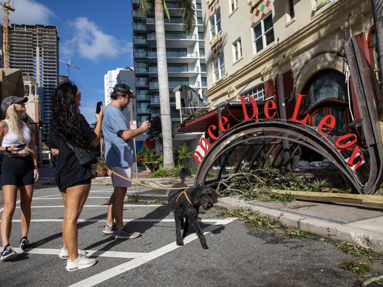 People check out damage from Hurricane Milton at the Ponce de Leon in St. Petersburg.