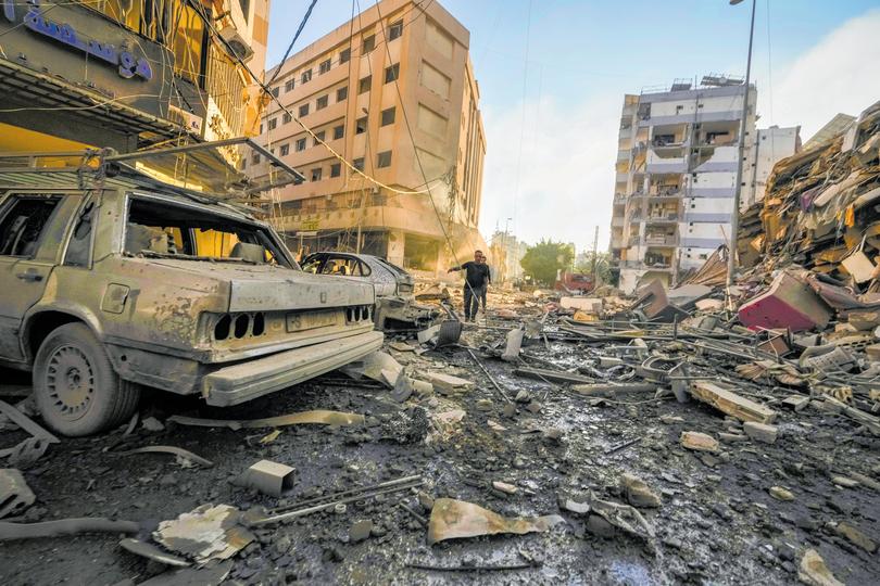 Residents run for cover following an airstrike in Beirut.