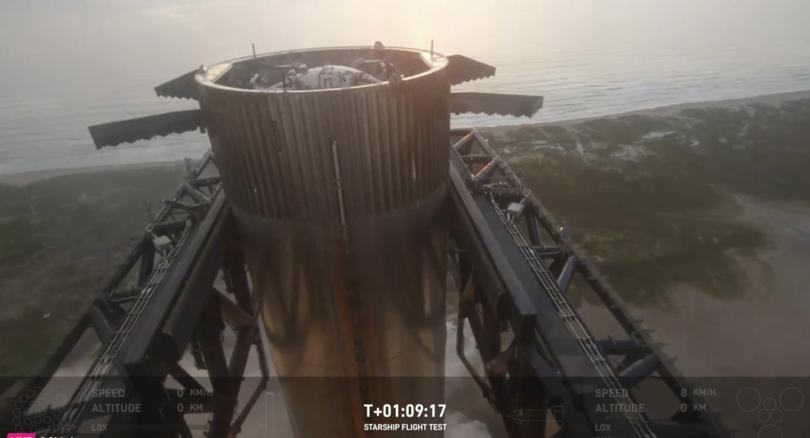 This image provided by SpaceX shows SpaceX's mega rocket booster returning to the launch pad to be captured during a test flight Sunday, Oct. 13, 2024, in Boca Chica, Texas. (SpaceX via AP)