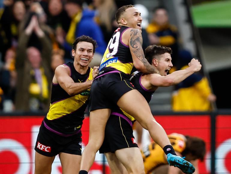 Liam Baker celebrates a match-winning goal with teammates Shai Bolton and Daniel Rioli last year.