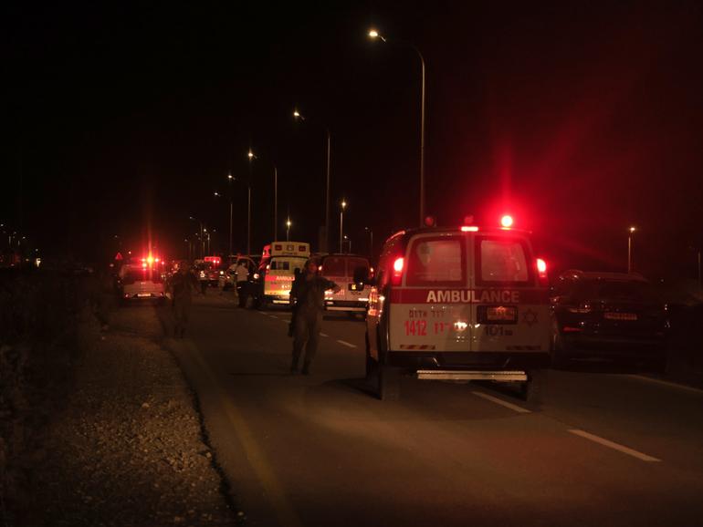 Emergency services personnel attend the scene of a drone strike in Binyamina, Israel.