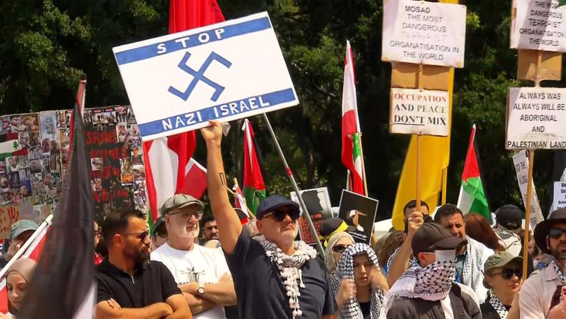 Protesters wave flags during a Pro-Palestine rally in Sydney, Sunday, October 6, 2024. 