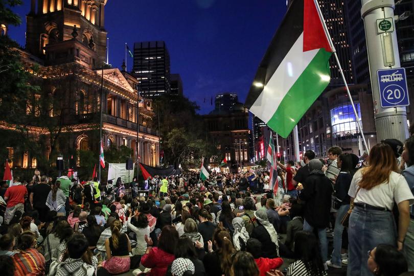 SYDNEY, AUSTRALIA - OCTOBER 07: People attend a vigil outside Sydney’s Town Hall on October 07, 2024 in Sydney, Australia. Organisers said the event was to remember lives lost in Gaza and Lebanon since October 7 last year. The organisers, Palestine Action Group, invited people of all faiths to “unite in solidarity in our call for justice and solidarity”. (Photo by Roni Bintang/Getty Images)