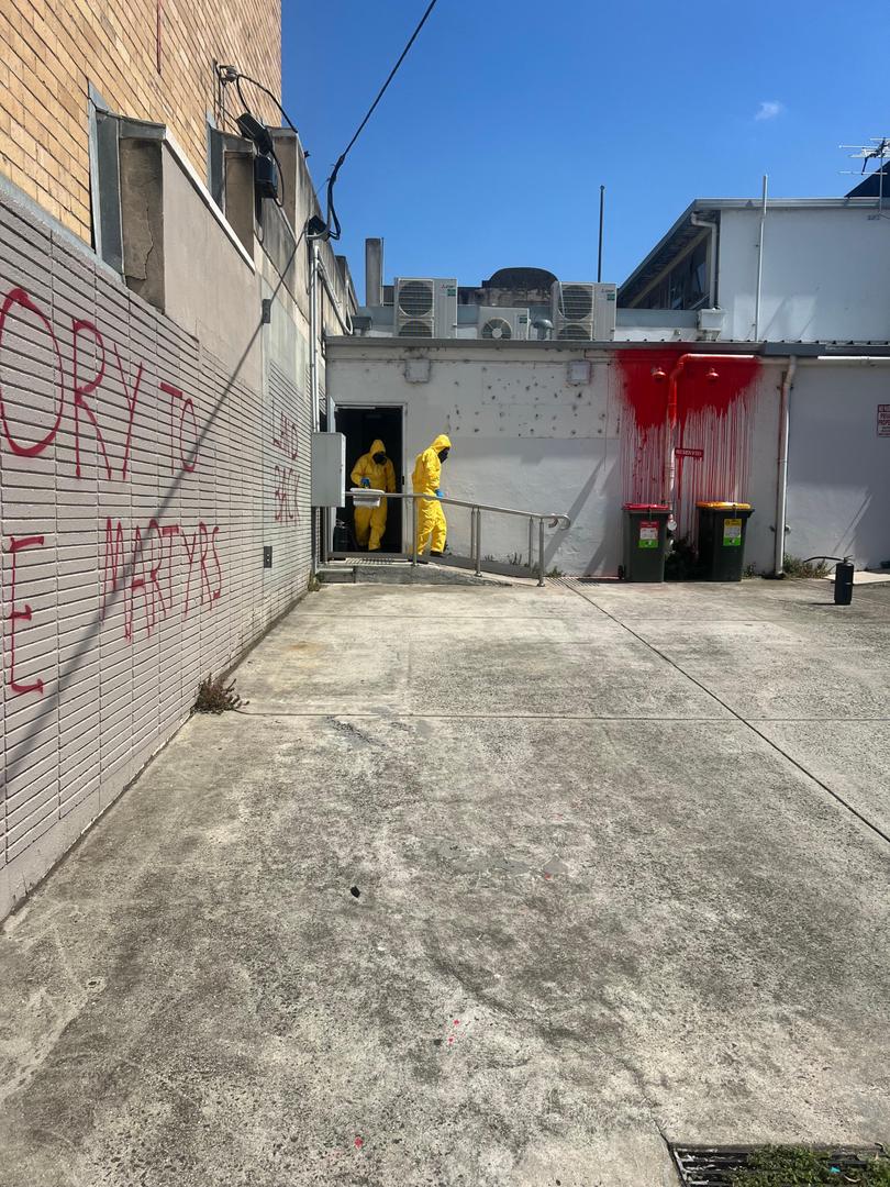 Workers at the scene of the vandalism attack.