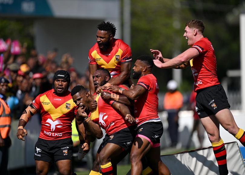 Judah Rimbu of PNG celebrates scoring a try against the Australian Prime Minister’s XIII on Sunday.