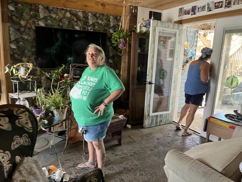 Lisa Johnson and Dana Raco in their home in Fort Myers Beach, Fla., on Thursday, following flooding from Hurricane Milton. MUST CREDIT: Brianna Sacks/The Washington Post