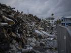 A pile of debris remains just steps from the beach in Fort Myers Beach, Fla., in June 2023, almost nine months after Hurricane Ian ravaged the area. MUST CREDIT: Thomas Simonetti for The Washington Post