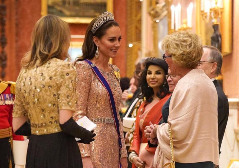 Catherine, the Princess of Wales, greets guests at Buckingham Palace.
