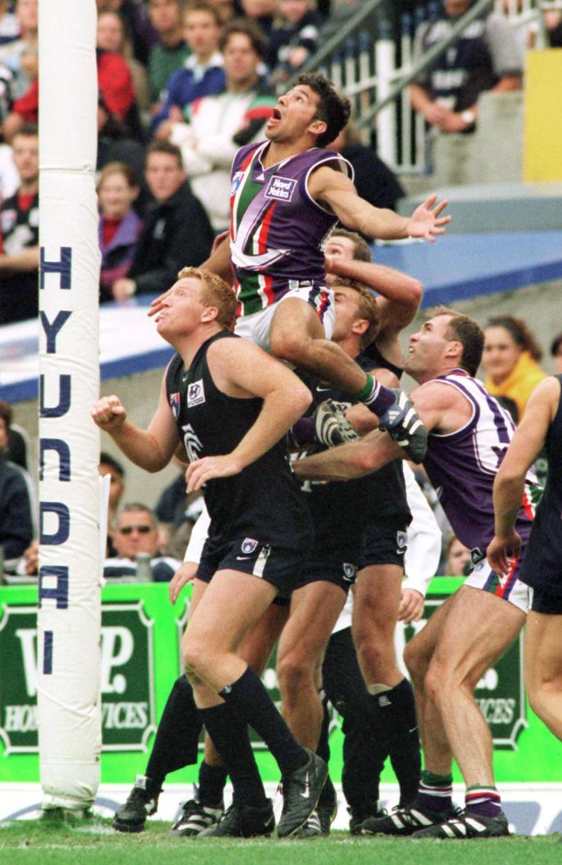 Darren Bolton from Fremantle soars above the pack for an attempted mark.