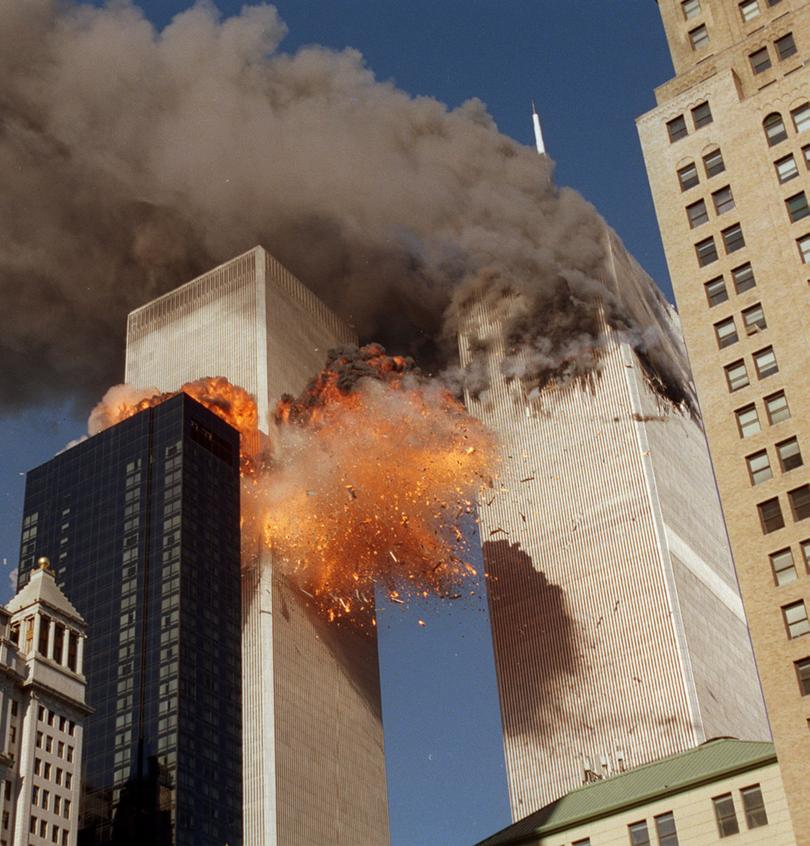 Smoke billows from one of the towers of the World Trade Center and flames and debris explode from the second tower, Tuesday, Sept. 11, 2001. In one of the most horrifying attacks ever against the United States, terrorists crashed two airliners into the World Trade Center in a deadly series of blows that brought down the twin 110-story towers. (AP Photo/Chao Soi Cheong)