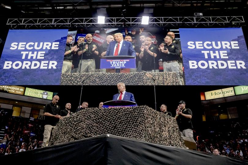 Former President Donald Trump speaks while joined onstage by members of border patrol during a rally at Findlay Toyota Center in Prescott Valley, Ariz., Oct. 13, 2024. TrumpÕs plans as outlined here were the latest reminder that when it comes to his vision for border security, hyperbolic rhetoric, rather than substantive solutions, often wins out. (Anna Watts/The New York Times)