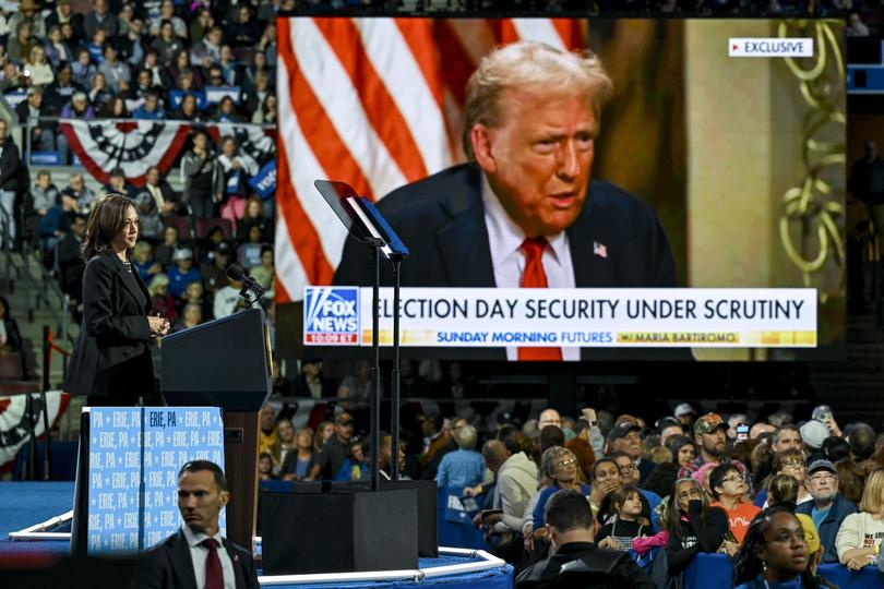 Vice President Kamala Harris, the Democratic presidential nominee, shows a video clip of former President Donald Trump vowing to go after people who oppose him, during a campaign rally in Erie, Pa., Oct. 14, 2024. 