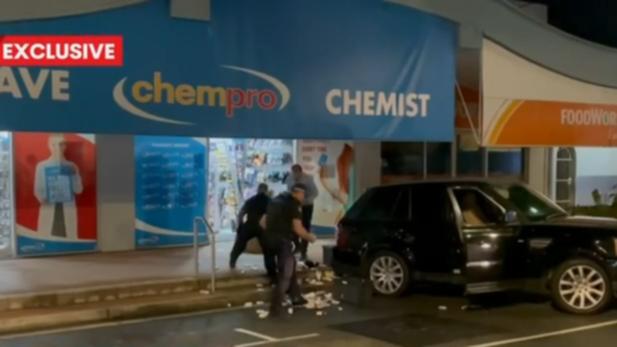 A woman has been arrested and a man is on the run after an alleged break-and-enter of a Gold Coast chemist.