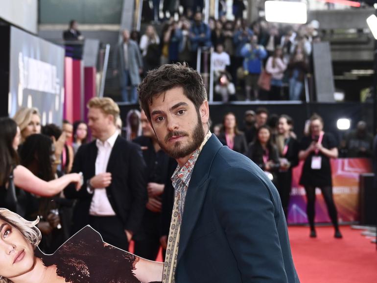 Andrew Garfield poses with a cardboard cutout of Florence Pugh at the We Live In Time Headline Gala. 