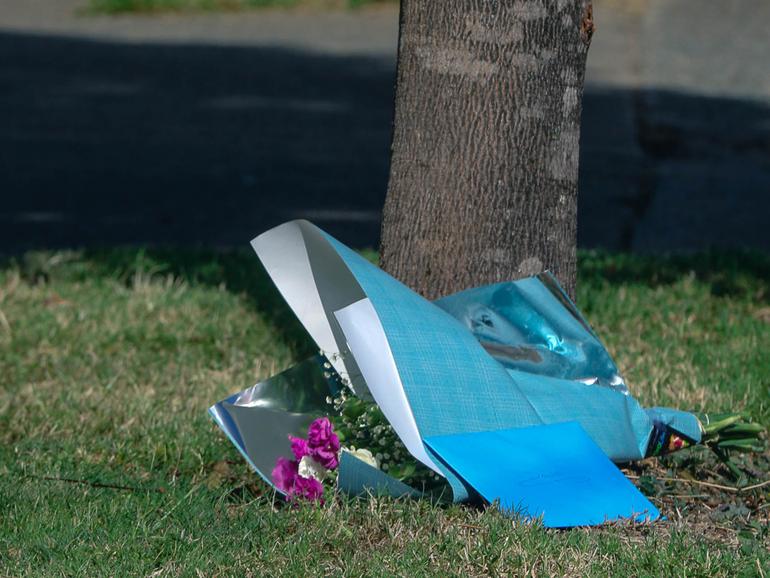 Floral tributes left at the scene where David Connolly died after he was stabbed in the chest in Brisbane in January 2023. 