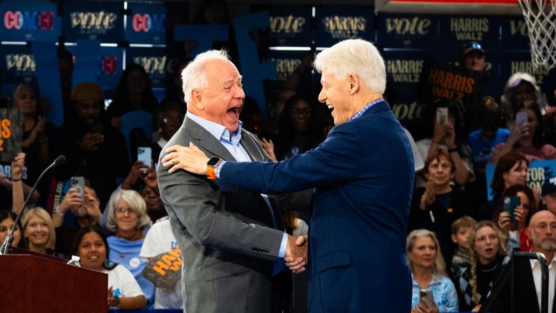 Minnesota Gov. Tim Walz (D) speaks at a rally in Durham, N.C., for the first day of early voting, accompanied by former president Bill Clinton, right. MUST CREDIT: Cornell Watson for The Washington Post